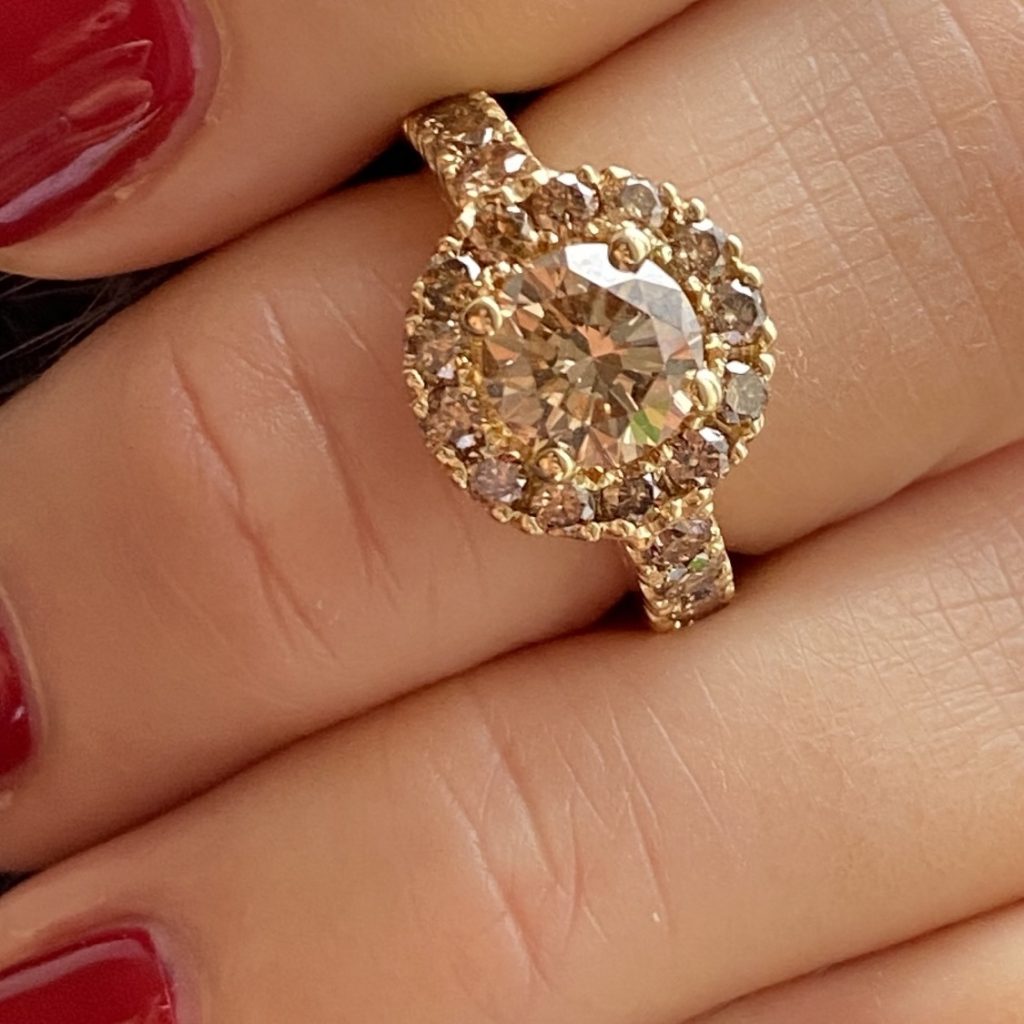 A halo ring with champagne coloured diamonds